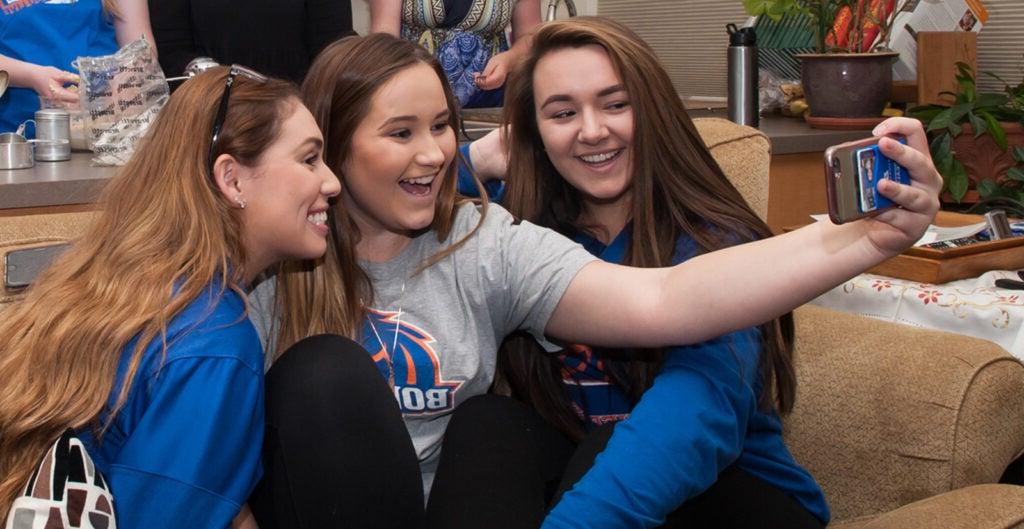 Boise State students take a selfie in a residence hall on campus