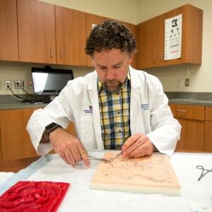 A Nursing student practices at the Boise State lab