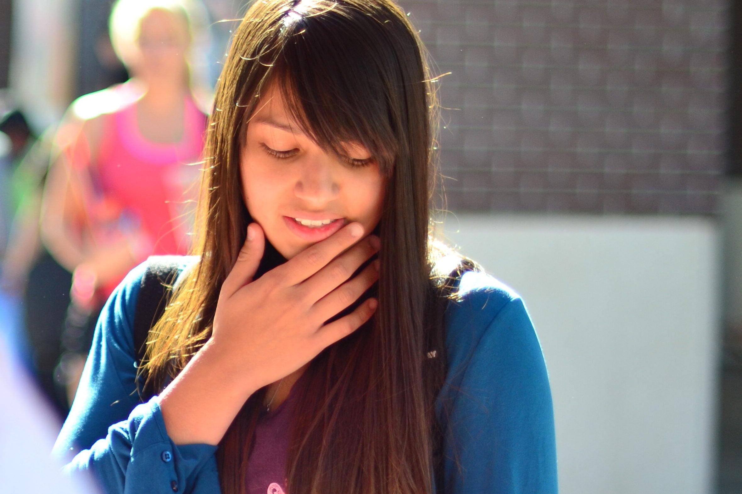 Student with hand on face contemplating something